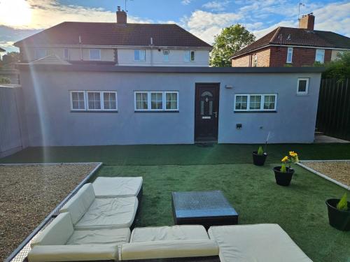 a backyard with a couch and a house at Our beautiful little house makes you stay magical in Bristol