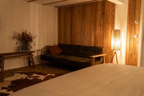 a living room with a couch and a table at Alva - Rhön Panorama Ferienhaus in Frankenheim