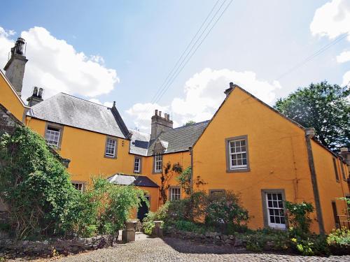 an old yellow house in a small village at Lochside Garden House - S4484 in Town Yetholm