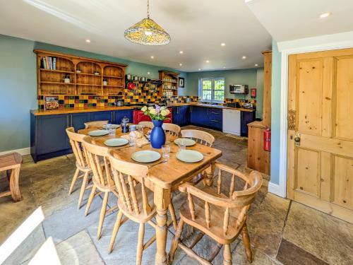 a dining room with a wooden table and chairs at Oakridge in Hinderwell