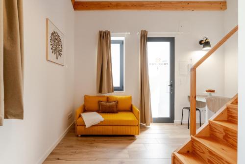 a living room with a yellow couch in a room at Authentic Studio with Terrace by HostWise in Porto
