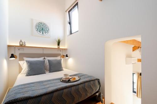 a bedroom with a bed with a tray on it at Authentic Studio with Terrace by HostWise in Porto