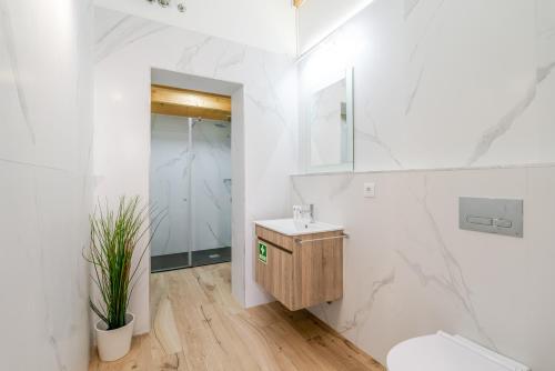 a white bathroom with a sink and a toilet at Authentic Studio with Terrace by HostWise in Porto
