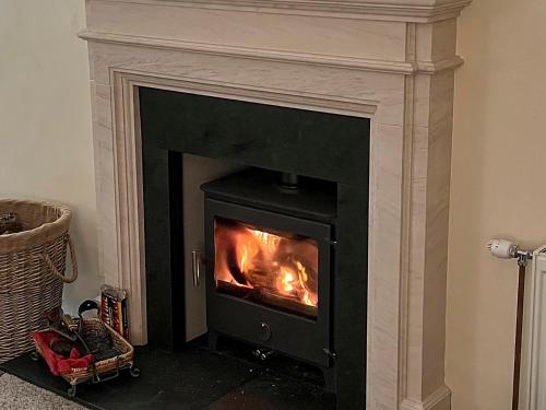 a fireplace with a fire in it in a room at Suisnish House in Ollach
