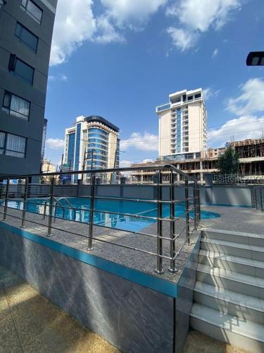 a swimming pool with buildings in the background at STAROOT residency in Nairobi