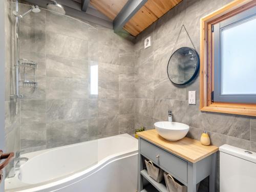 a bathroom with a white tub and a sink at 5 The Glades - Uk46753 in Tattershall