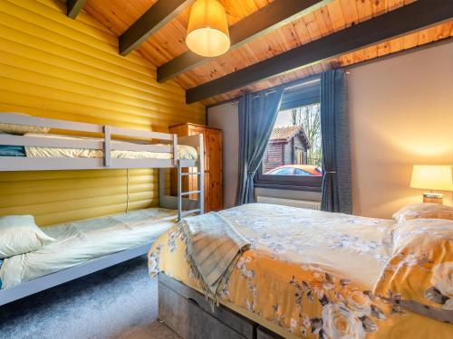 a bedroom with two bunk beds and a window at 5 The Glades - Uk46753 in Tattershall
