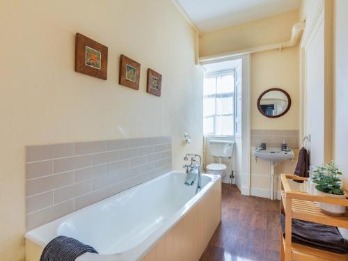 a bathroom with a large white tub and a sink at The Garden Apartment - Uk48320 in Berwick-Upon-Tweed