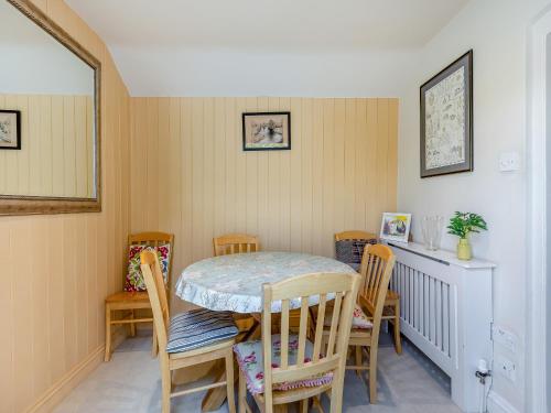 a dining room with a table and chairs at Stamford Townhouse in Stamford
