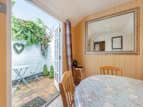 a bedroom with a large window and a view of a patio at Stamford Townhouse in Stamford