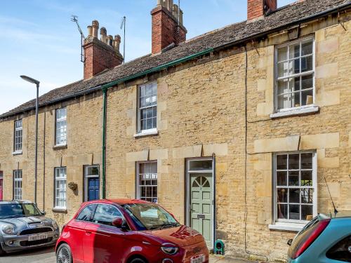 a red car parked in front of a brick building at Stamford Townhouse in Stamford