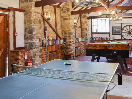 a ping pong table in a room with a piano at Mill Apartment - Ukc3784 in West Down