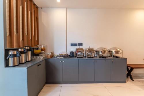 una cocina con una encimera con muchos utensilios en Treebo Urban Nest, en Ernakulam