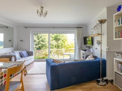 a living room with a blue couch at Rockvale 1 in Salcombe