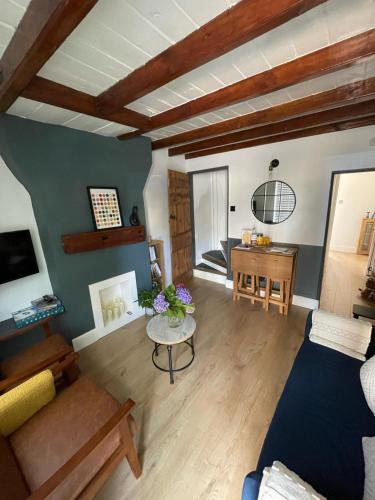 a living room with a couch and a table at Charming cozy cottage in Guisborough in Guisborough