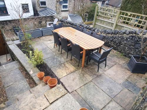 a wooden table and chairs on a patio at Verona House in Tideswell