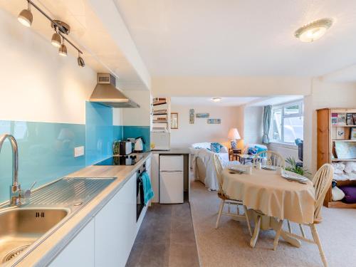 a kitchen and dining room with a table and a room at The Lookout in Torquay