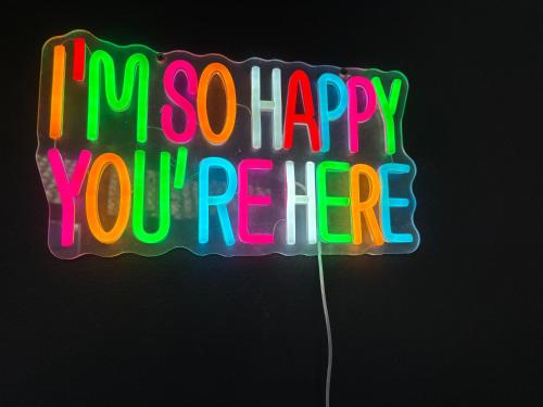 a neon sign that says happy youre at The Folly Guest House - Sleeps 28 in Kilkenny