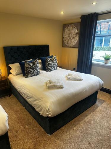 a large bed in a bedroom with a window at The Goodrington Sands- Apart Hotel in Paignton