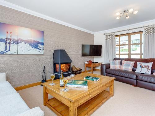 a living room with a couch and a fireplace at The Lookout in Aviemore