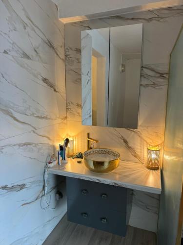 a bathroom with a sink and a mirror at Villa Ti Paradis in Sainte-Luce