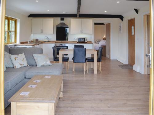 a living room with a couch and a table at Horseshoe Cottage in Alkham