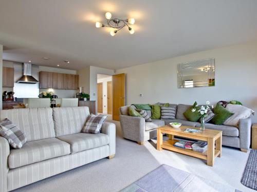 a living room with two couches and a table at Harbreck Heights -Masts B9 in Torquay