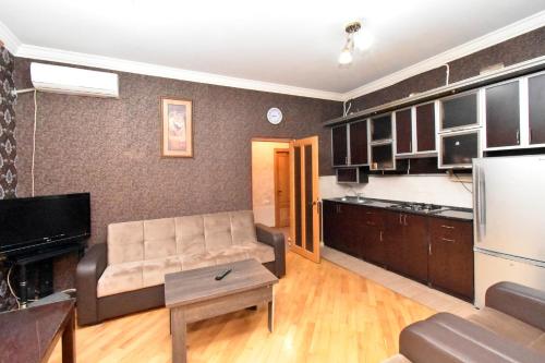 a living room with a couch and a kitchen at Apartment in Glendel Hill in Yerevan