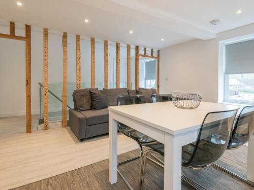 a living room with a table and a couch at The Norfolk-Uk41442 in Brandon