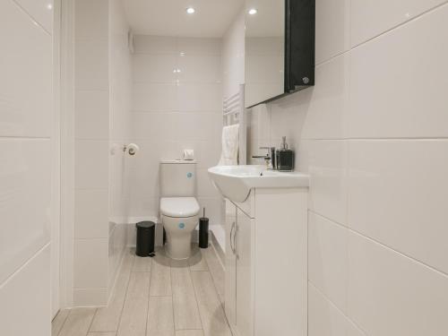 a white bathroom with a toilet and a sink at The Norfolk-Uk41442 in Brandon