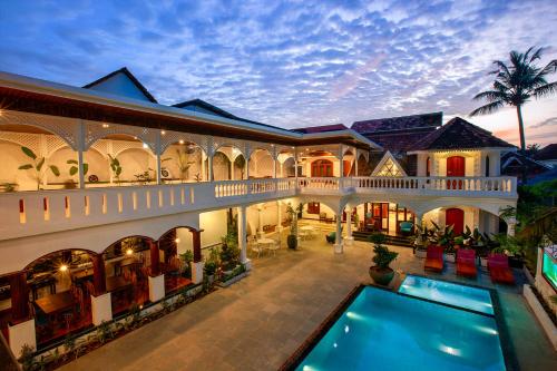 an exterior view of a house with a swimming pool at Villa Elixir Fort Kochi in Cochin
