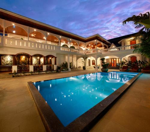 a swimming pool in the middle of a building at Villa Elixir Fort Kochi in Cochin