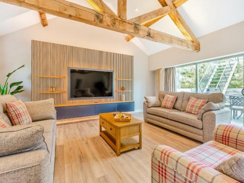 a living room with two couches and a tv at Property 4 - Uk44924 in Wroxall