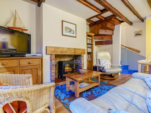 a living room with a fireplace and a tv at Sayers Yard in Whitby