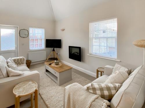 a living room with two couches and a tv at The Guards Quarters - Uk47594 in Silloth