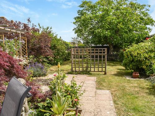 a garden with a gate in the yard at The Old Thatch in Hailsham