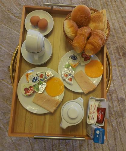 a wooden tray with breakfast food on a table at Settle Inn Mirage Boutique Hotel in Cairo