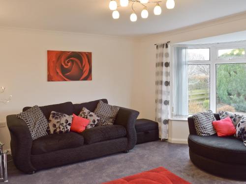 a living room with a couch and a chair at Polperro in Keswick
