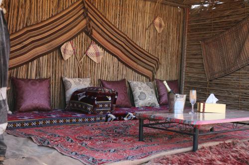 a living room with a couch and a table at Just For You Starwatching Tent in Al Wāşil