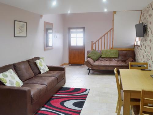 a living room with a couch and a table at Valley View - 29530 in Scotforth