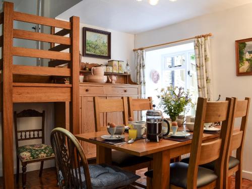 a dining room with a table and a loft bed at Burrills View in Horderley