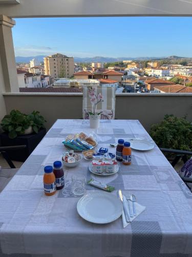 a white table with plates of food on a balcony at Tra Mare & Monti - Bed & Breakfast in Olbia