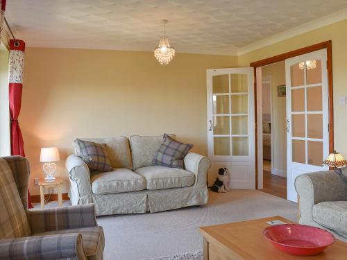 a living room with a couch and a table at The Orchard in Bideford