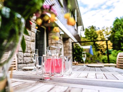 a wooden table with glasses on top of it at Moorlands in Chilcompton