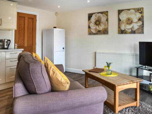 a living room with a couch and a table at Marina Haven in Carnforth