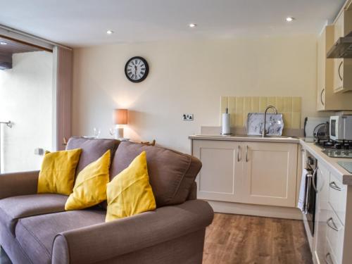 a living room with a couch and a kitchen at Marina Haven in Carnforth