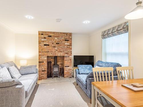 a living room with a couch and a fireplace at Salem Porter- Uk34814 in Tattershall