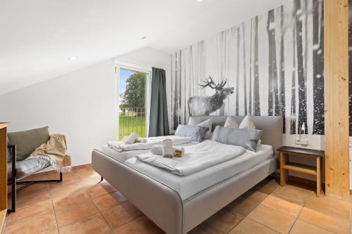 a bedroom with a bed with a deer on the wall at BALANCED Eurasburg Apartments, vollausgestatte Ferienwohnungen auf dem Land in Eurasburg