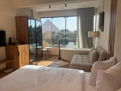 a hotel room with a bed and a bath tub at Palacio Pyramids Hotel in Cairo