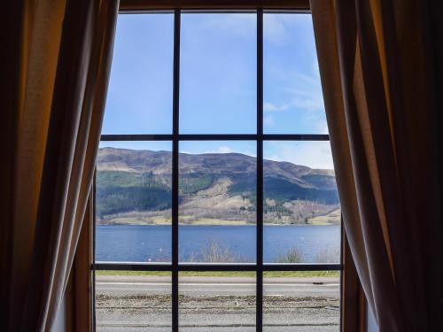 a view of a lake from a window at Quarter Deck Gardens in Glencoe